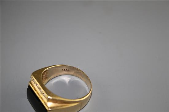 A 14k yellow metal, diamond and black onyx set dress ring, size U/V, gross weight 8.4 grams.